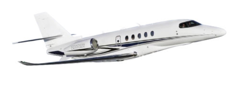 A white private jet with two engines and swept wings is flying in the sky, viewed from the side.