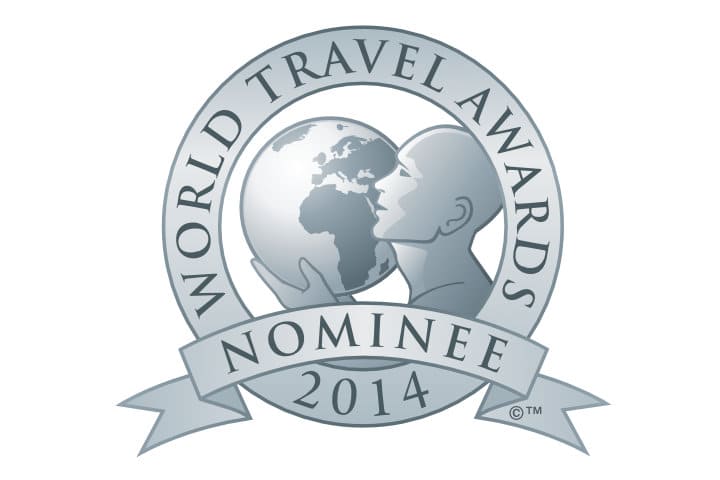 Circular "World Travel Awards Nominee 2014" logo featuring a stylized person holding and looking at a globe, with text on a banner below.