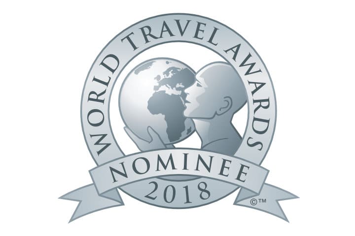 Silver World Travel Awards Nominee 2018 logo featuring a stylized figure holding a globe, surrounded by a circular banner.
