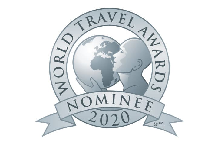 World Travel Awards 2020 nominee logo featuring a stylized globe held by a human figure, with text on a circular badge and banner.