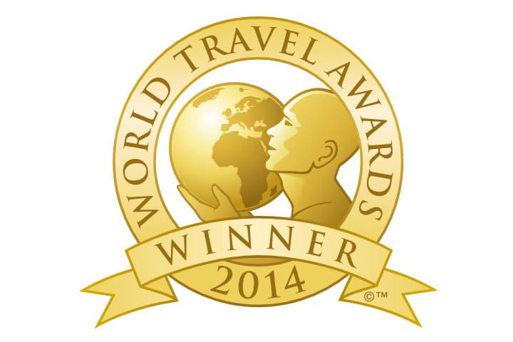 World Travel Awards 2014 winner gold logo featuring a stylized person holding a globe, surrounded by a circular frame and banner.